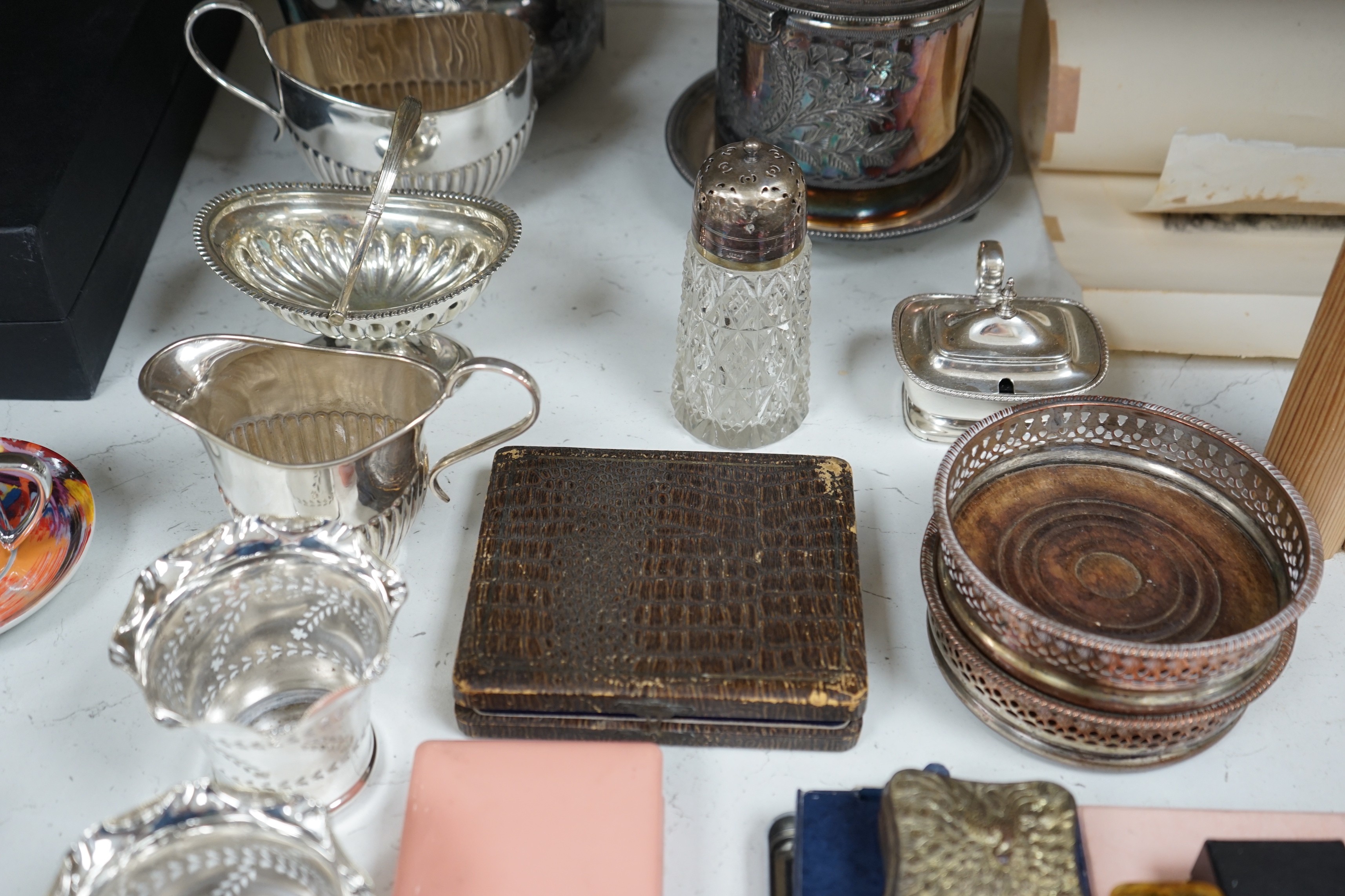 A collection of mixed silver plated wares, to include a pair of wine coasters, cream jug, novelty spoons, etc.